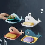 Three shark-shaped plates with food on a dark background