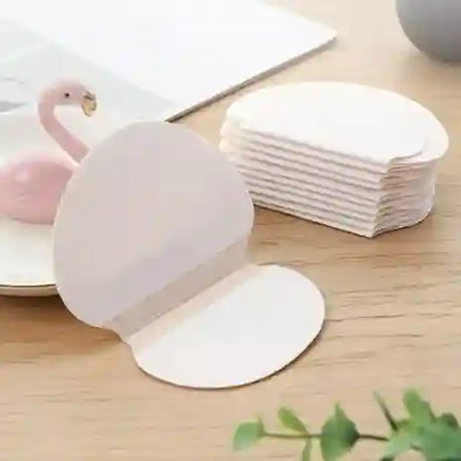 White Swan-shaped napkin holder with a stack of white napkins on a wooden surface.