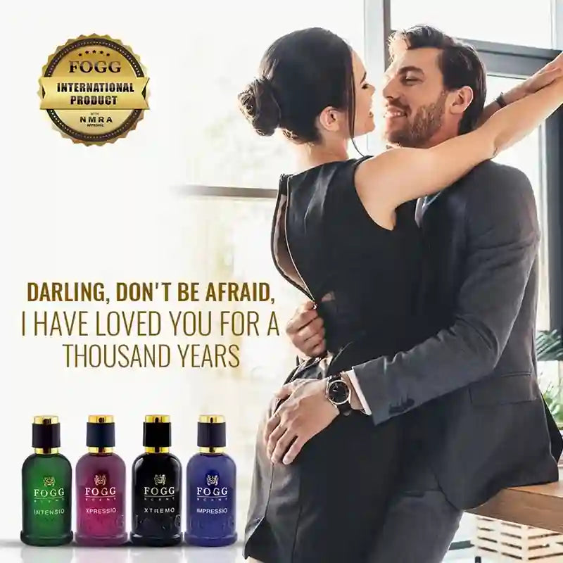 A couple embracing in a bright indoor setting, with four small fragrance bottles shown along the bottom and marketing text reading 'DARLING, DON'T BE AFRAID, I HAVE LOVED YOU FOR A THOUSAND YEARS' and a gold FOGG INTERNATIONAL PRODUCT seal.