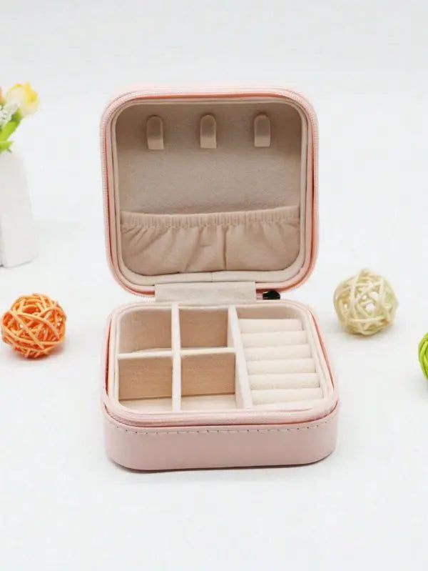 Pink jewelry box with open lid on a white background