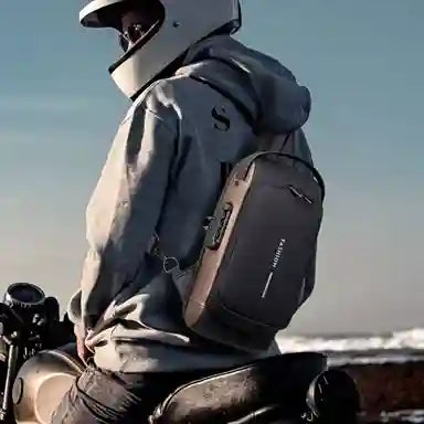 Person wearing a helmet and backpack sitting on a motorcycle with a clear sky background
