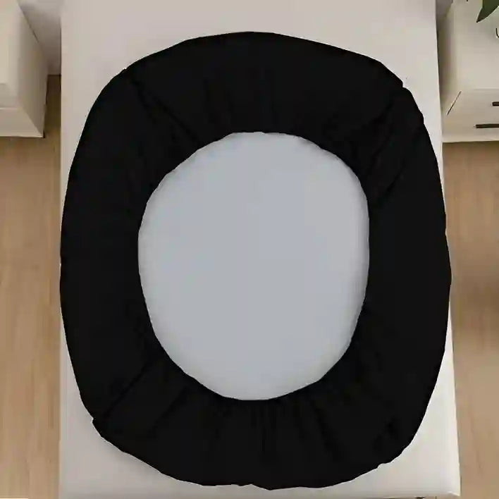 Black toilet seat cover on a white toilet