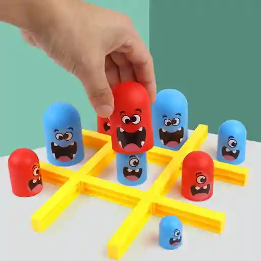 Colorful toy game with cartoon face pieces on a white surface against a light green background