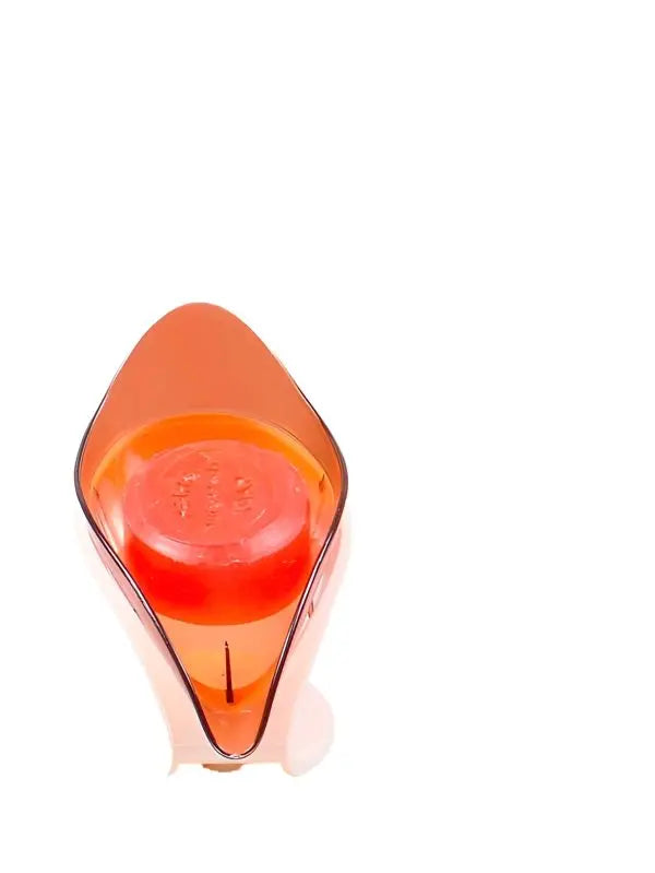 Orange and clear plastic object on a white background