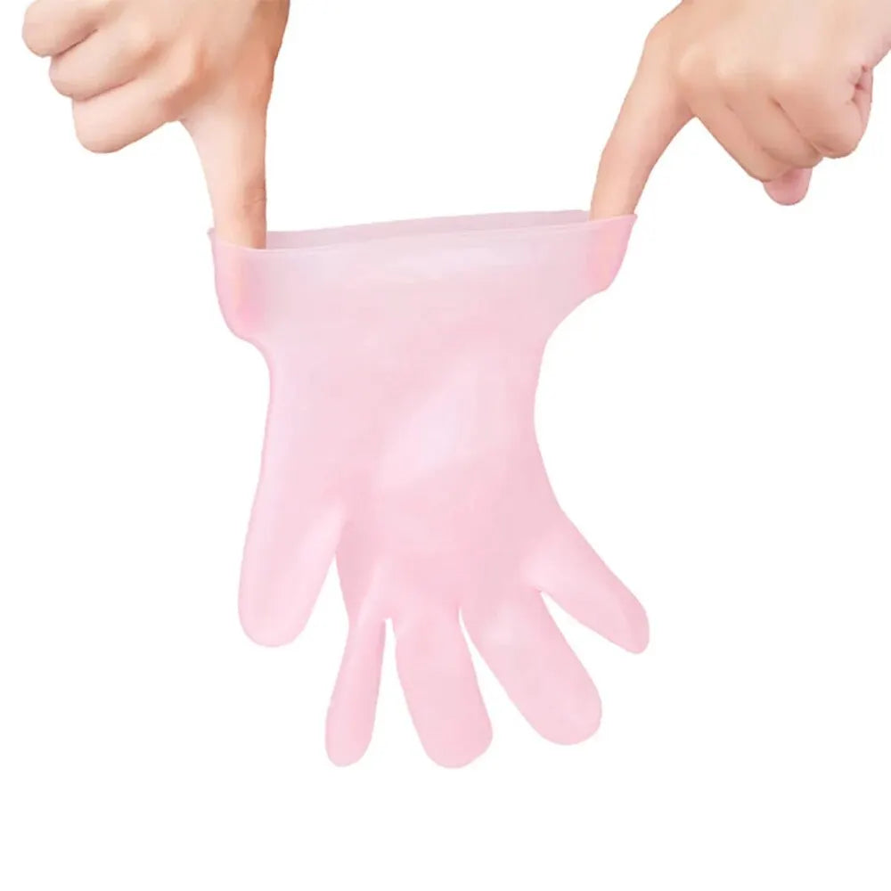 Pink gloves being worn on a white background