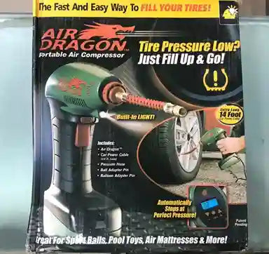 Air Dragon portable air compressor packaging on a reflective surface