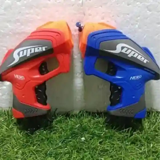 Two toy blasters, one red and one blue, with 'Super Hero' branding on a grassy surface.