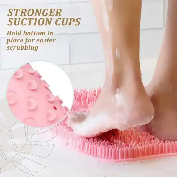 Person using a pink scrubber with suction cups on a tiled bathroom floor.
