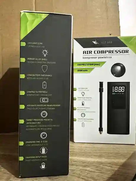 Air compressor packaging with specifications on a wooden surface