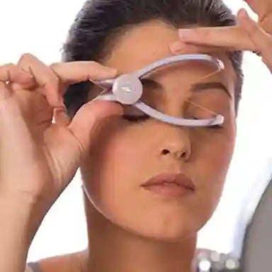 Person using a facial roller device on their face with a blurred background