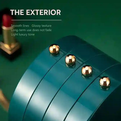 Close-up of a teal product with gold accents on a green background, featuring text about the exterior.