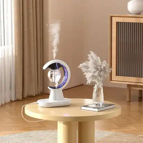 Tabletop humidifier emitting mist on a round wooden table with a decorative plant in a room.