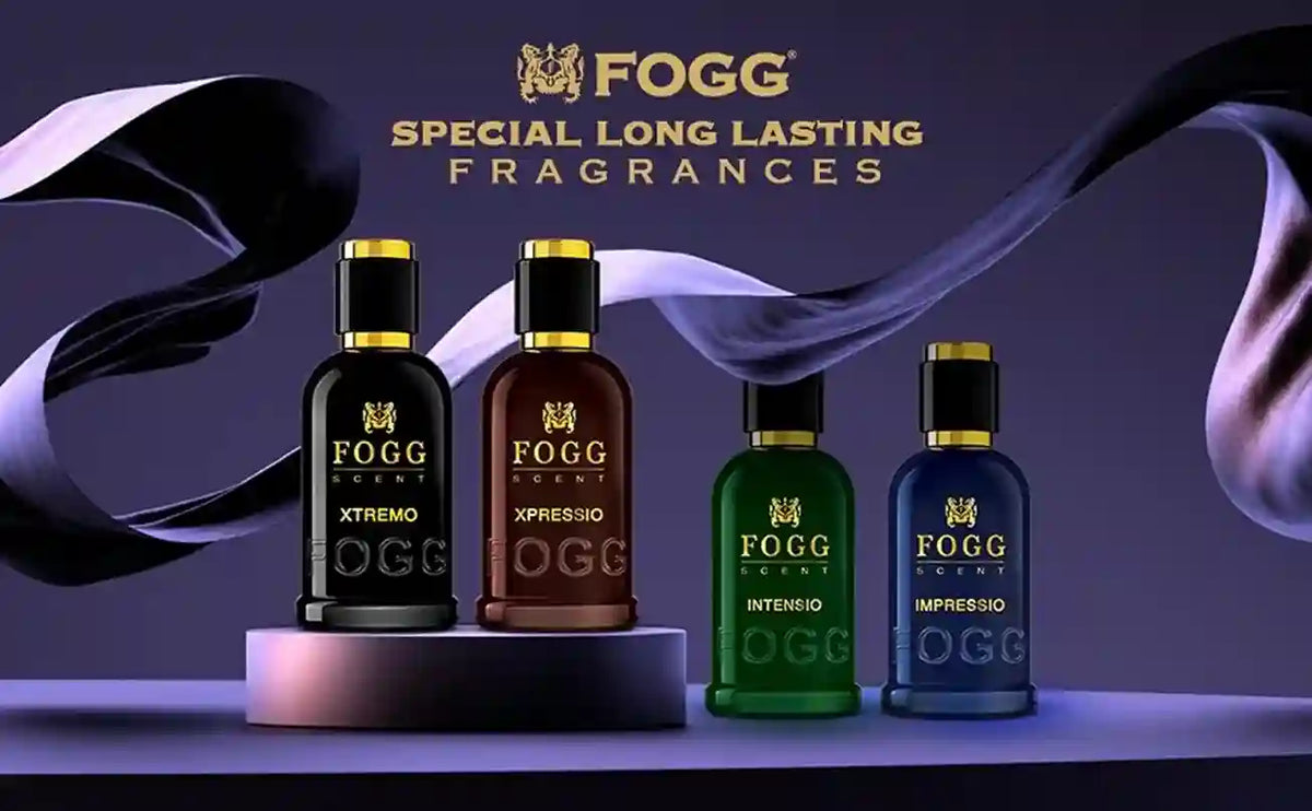 Four Fogg Fragrances bottles displayed on a dark purple background with flowing black and white ribbon graphics. The bottles are Xtremo (black), Xpressio (brown), Intenso (green), and Impreso (blue), with gold caps and gold lettering.