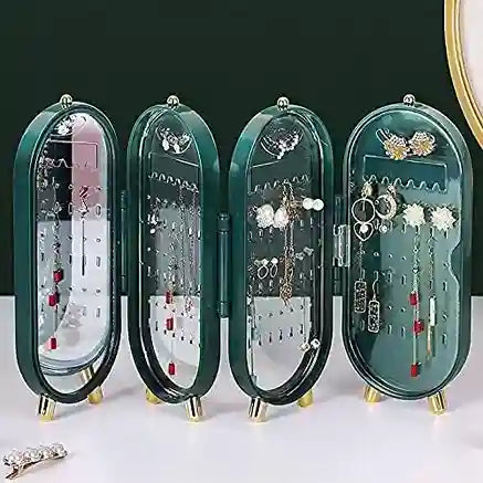 Green jewelry organizer with multiple compartments displaying earrings on a white background