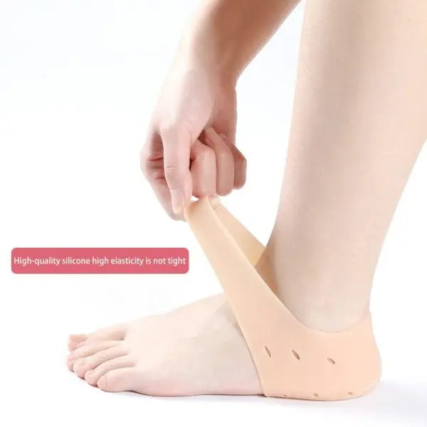 Person wearing a silicone foot sleeve on a white background