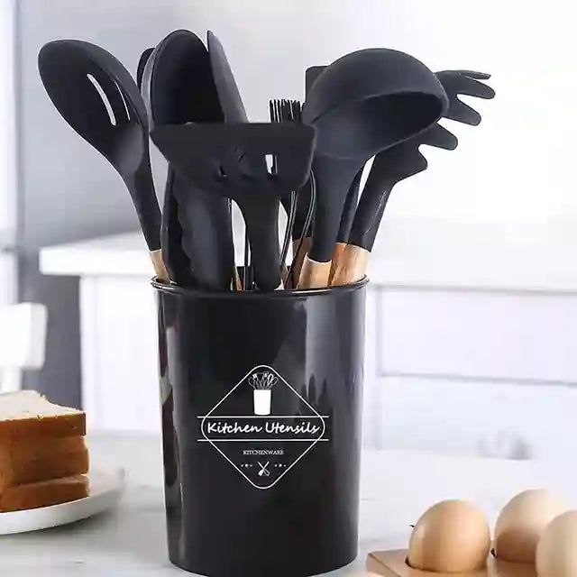 Black kitchen utensil holder with various utensils on a kitchen counter.