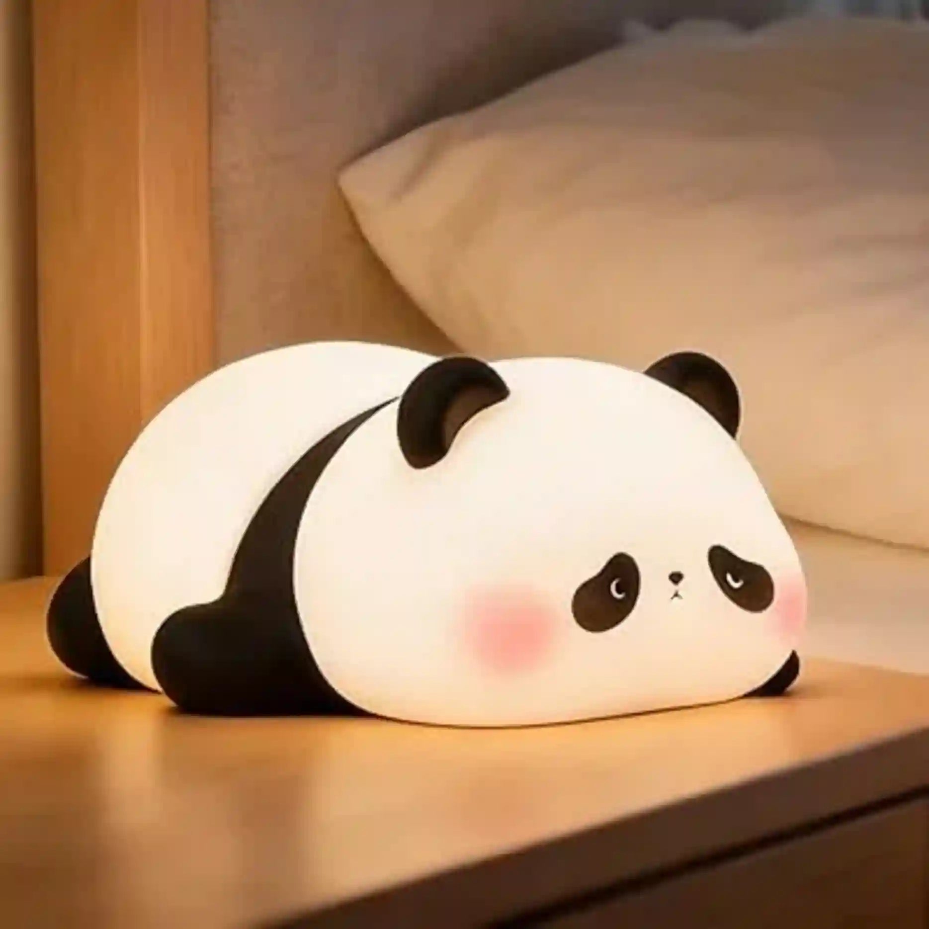 Panda-shaped night light on a wooden surface with a soft focus background
