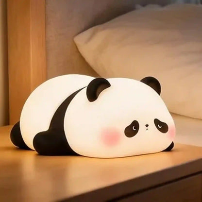 Panda-shaped night light on a wooden surface with a soft focus background