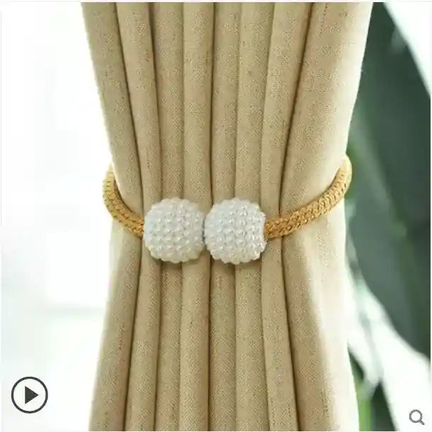 Curtain tieback with pearl-like beads on a beige curtain