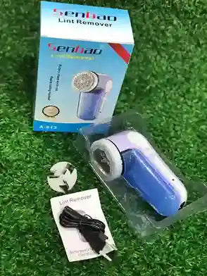 Senhao lint remover with packaging and accessories on a grassy background