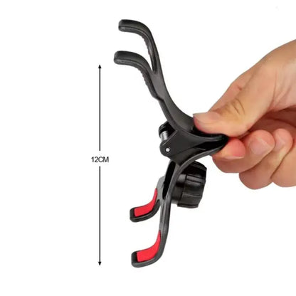 Hand holding a black and red bicycle brake lever with measurement label on a white background