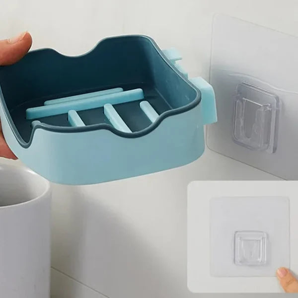 Blue soap dish with suction cup attached to a tiled wall