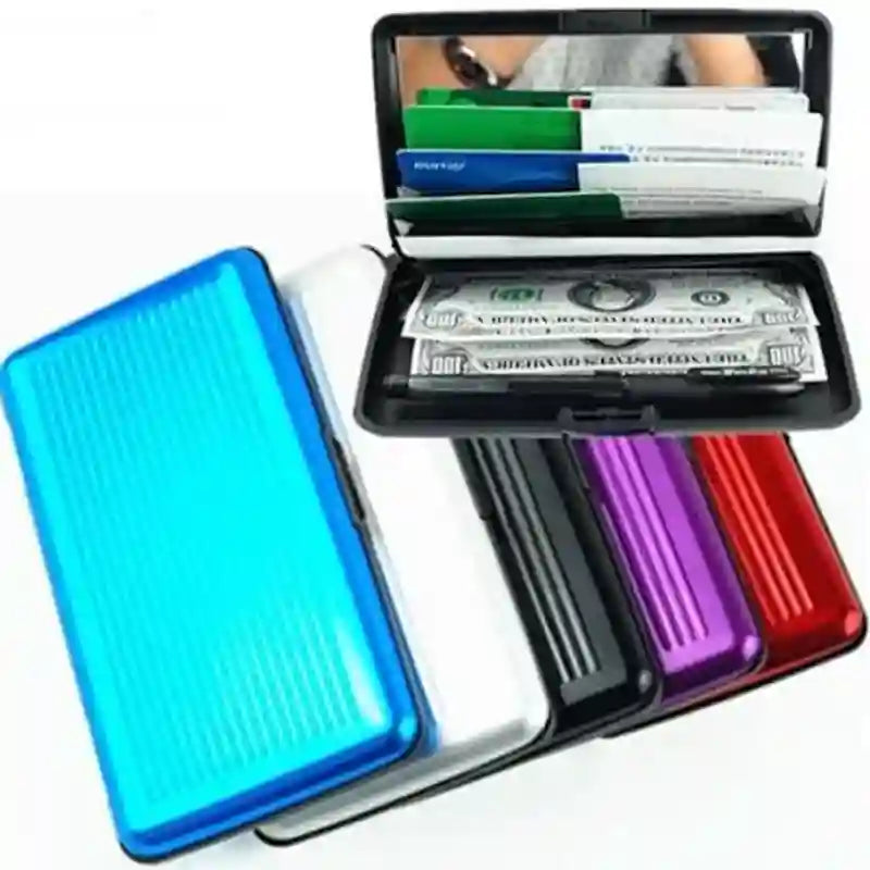 A stack of slim rectangular metal money-counting trays in blue, white, black, purple, and red, shown open with cash and cards inside on a white background.