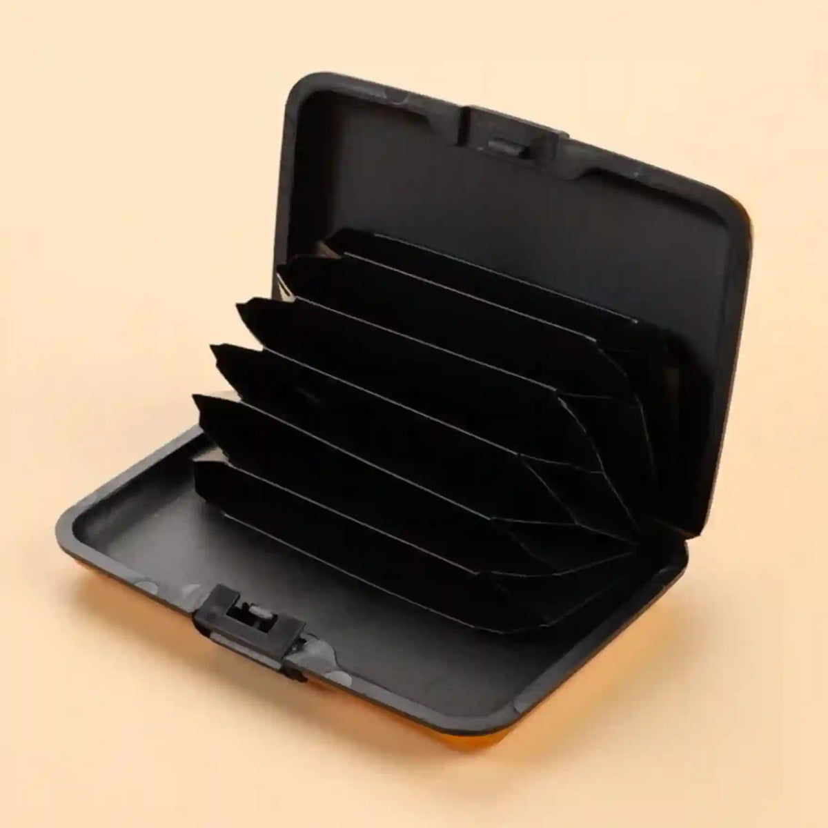Black hard-shell carrying case with compartments on a beige background