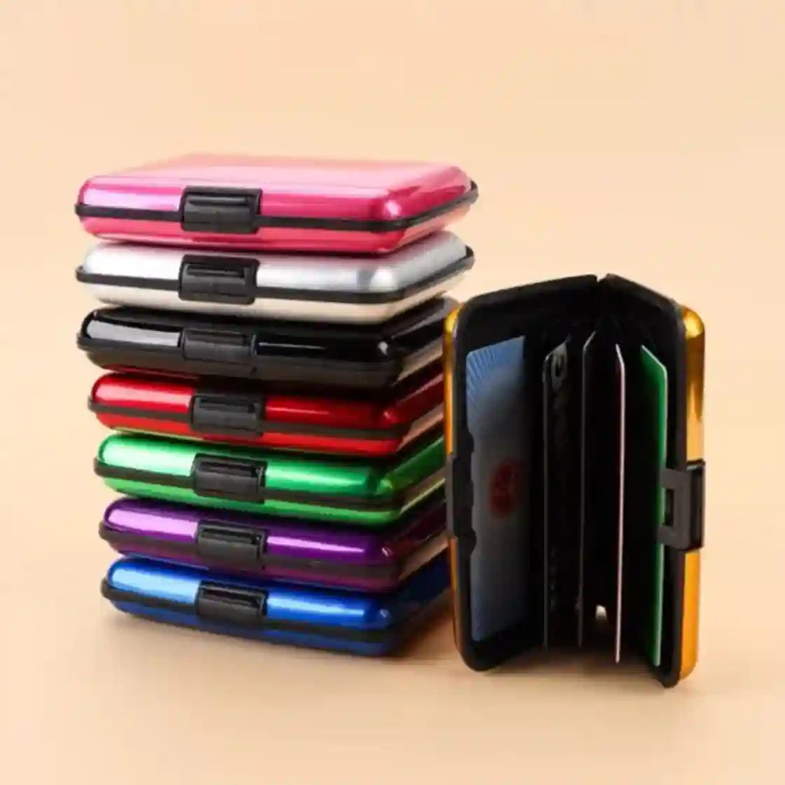 Stack of colorful metal card holders on a beige background
