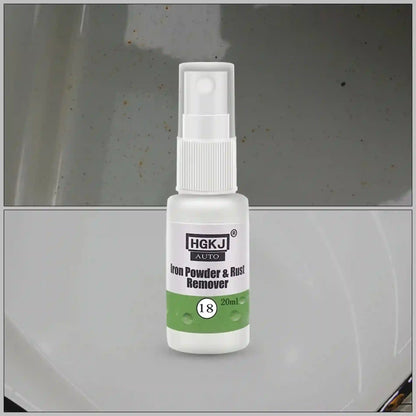 A small white spray bottle labeled HGKJ AUTO Iron Powder & Rust Remover, shown against a split background of a dirty metallic surface above and a clean metallic surface below.