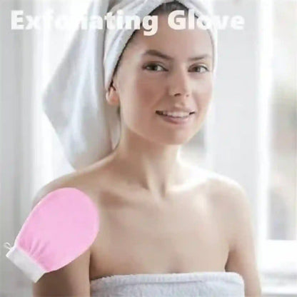 A woman wrapped in a white towel with a white towel turban on her head, holding a pink exfoliating glove on her shoulder. White text at the top reads 'Exfoliating Glove'.
