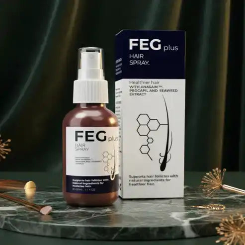FEG plus hair spray bottle and box on a dark surface with decorative elements.