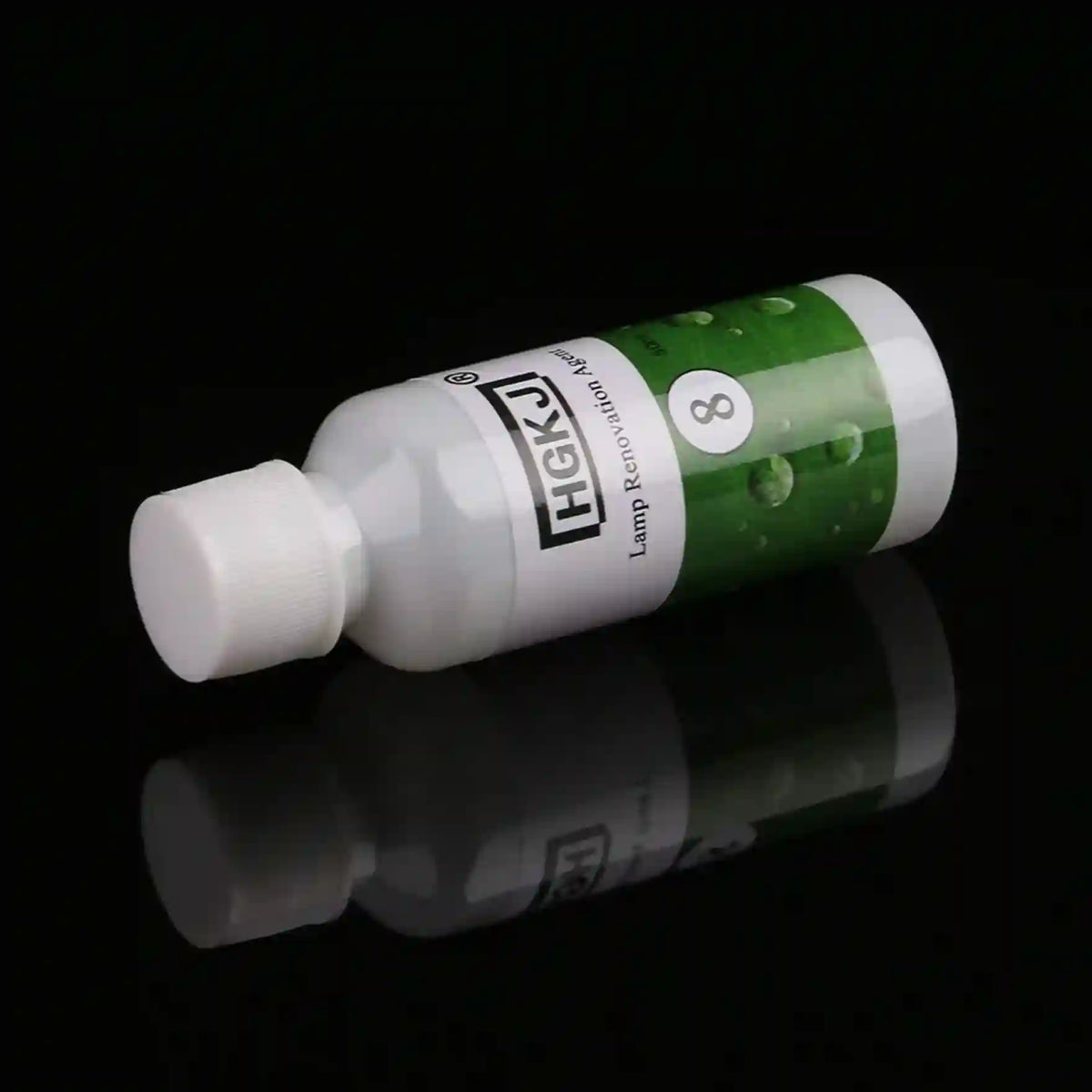 A small white plastic lamp refill bottle with a white cap, featuring a green and white label with the brand name 'HASK' and the number '8', set against a solid black background with a clear reflection below.