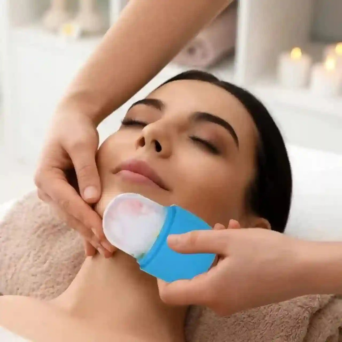 Person using a blue device on another person's face in a spa setting