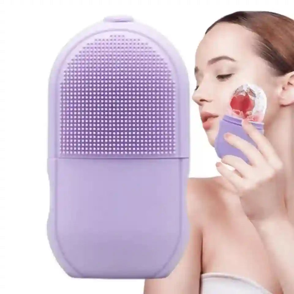 Purple facial cleansing brush held by a person on a white background