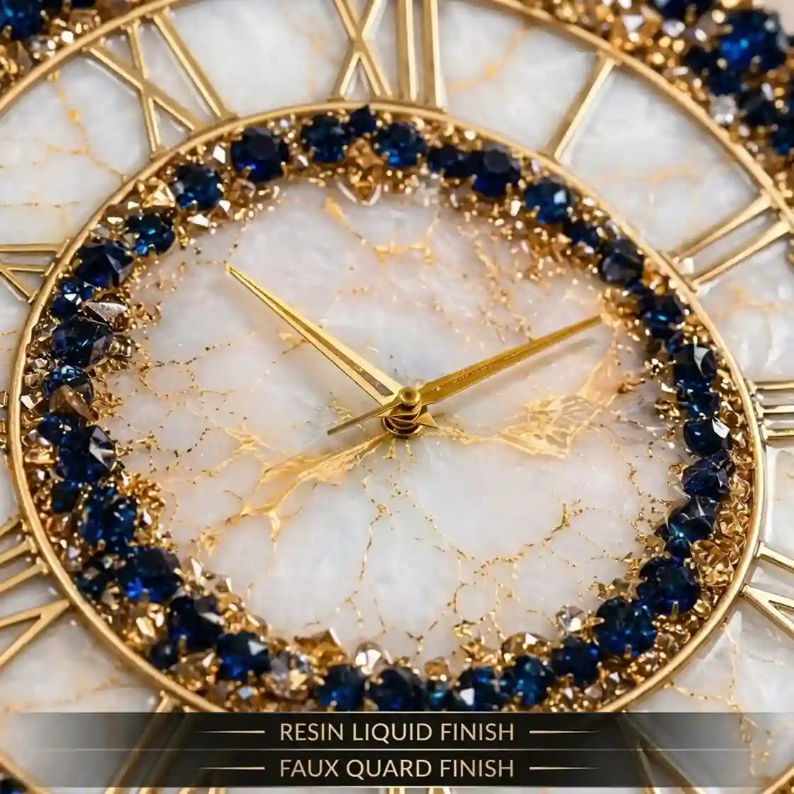 Close-up of a round wall clock with a gold-tone frame, Roman numerals, a white marbled dial, and a ring of deep blue faceted stones around the inner edge. Text at the bottom reads 'RESIN LIQUID FINISH' and 'FAUX QUARD FINISH'.