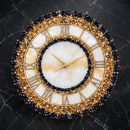 An ornate round wall clock with a gold-tone frame, white marble dial, Roman numerals, and dark blue gemstone accents, shown against a dark marble background.
