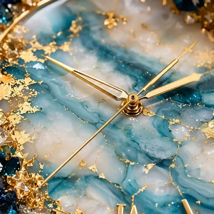 Close-up of a decorative round clock face with a blue and white marbled agate-like design, scattered gold leaf flakes, and gold-tone hands.