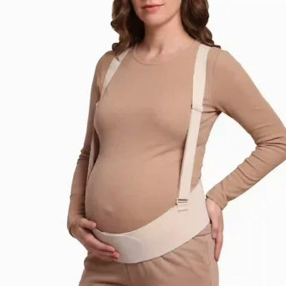 Woman wearing a beige maternity support belt on a white background