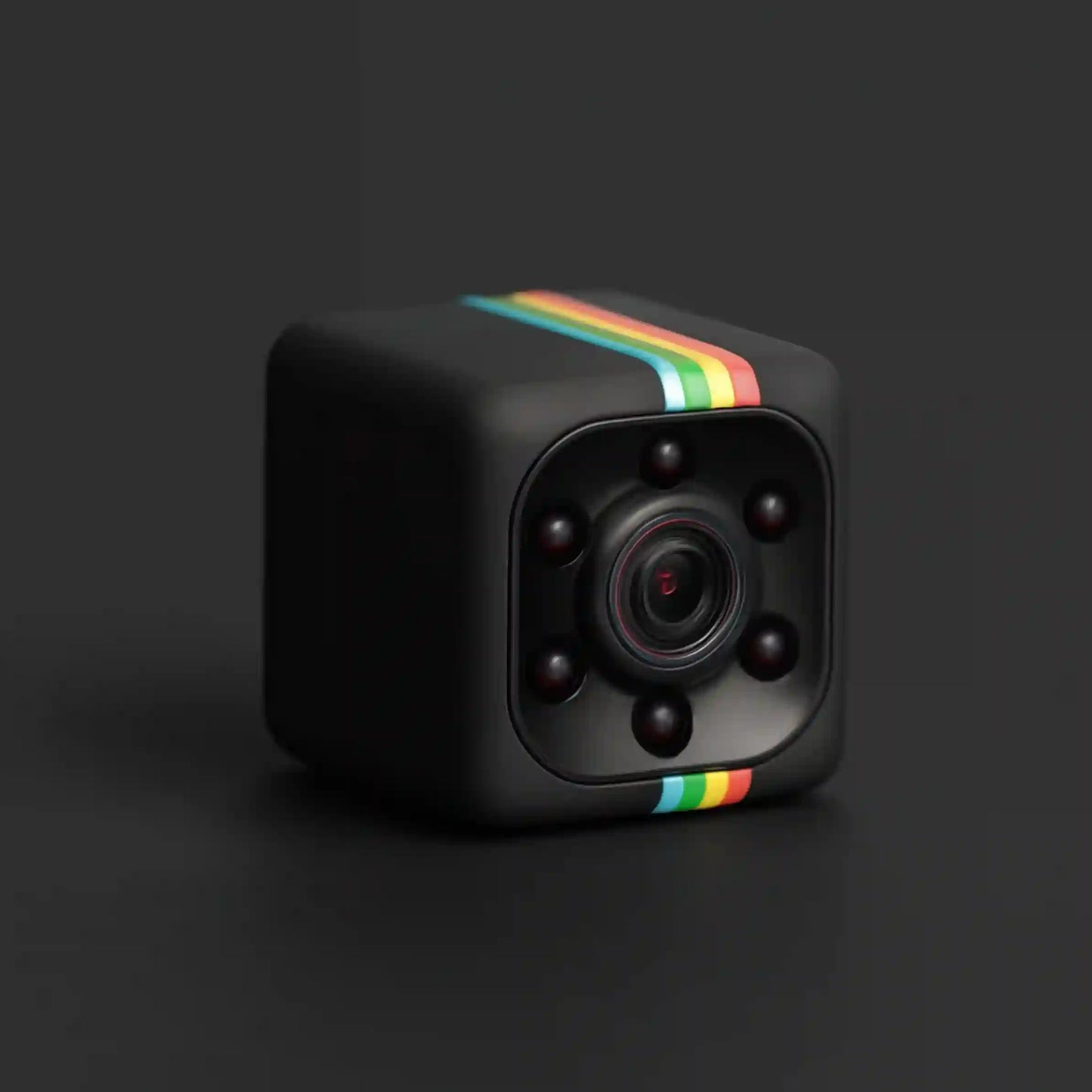 A black cube-shaped mini camera with a colorful rainbow stripe on the top and bottom edges, featuring a central lens surrounded by six dark sensors, set against a dark gray background.
