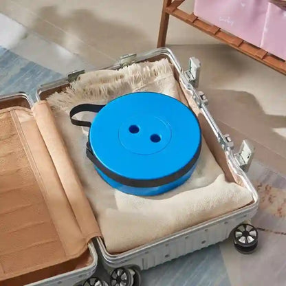 Blue spool with black handle inside an open suitcase on a tiled floor.