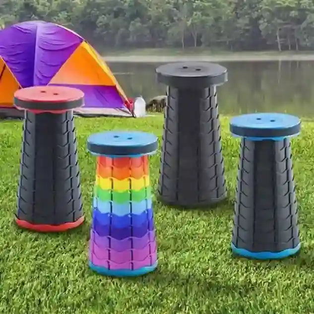Set of colorful folding stools on grass with a tent in the background