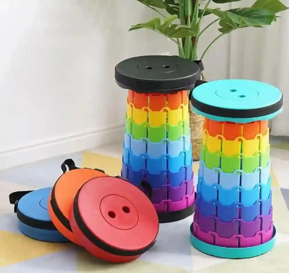Colorful button-shaped stools on a light wooden floor with a plant in the background.