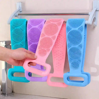 Colorful scrubber sets hanging on a rack with a hand reaching for one.