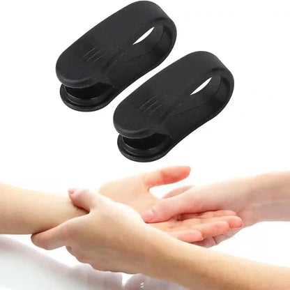 Two black silicone wrist band clamps shown above a photo of hands holding a wrist, demonstrating use on a human body part.
