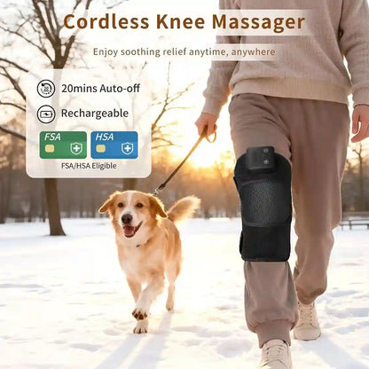 Person walking a dog in the snow wearing a cordless knee massager, with product features displayed.