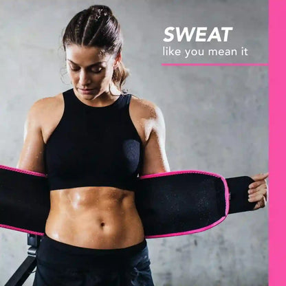 Woman wearing a black waist trainer with pink accents against a gray background.
