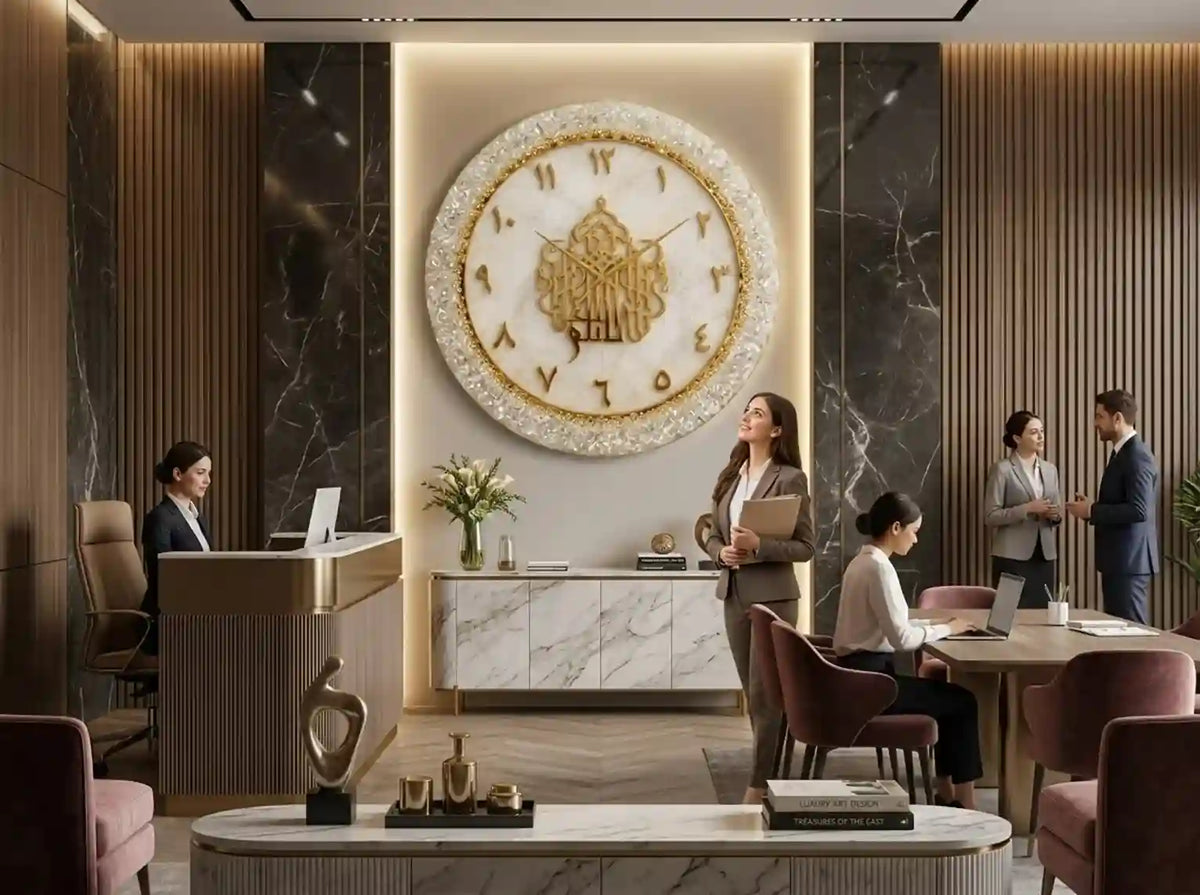 A large decorative wall clock with a gold and white floral emblem and Roman numerals hangs in a modern lobby. Several people are seen working and conversing in the lobby area around the clock.