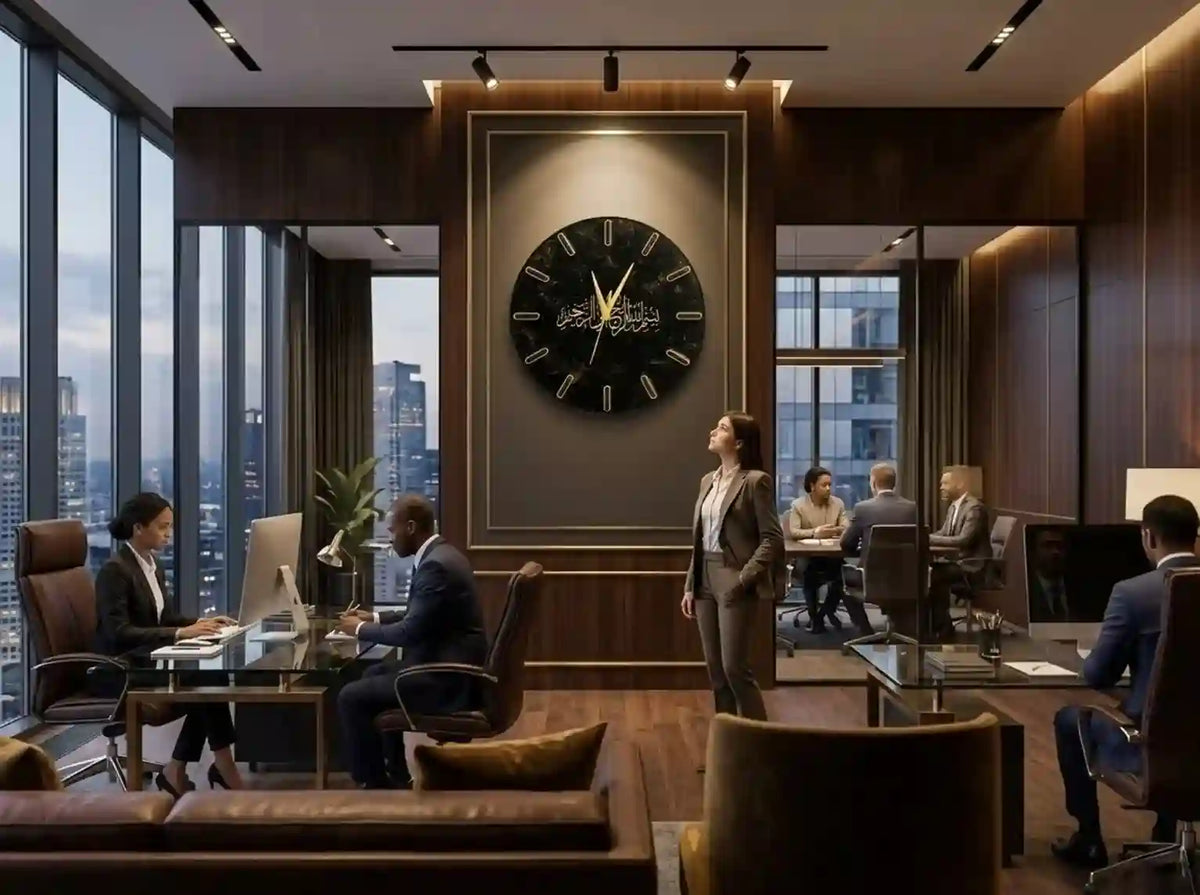 A large round black wall clock with gold Roman numerals and hands hangs on a dark wood-paneled wall in a modern office setting with several people working and standing nearby.